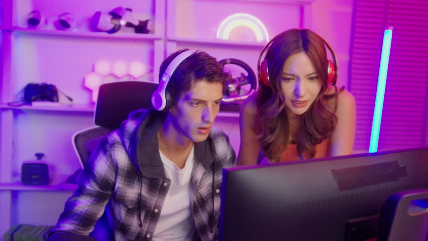 Young professionals play video games together live streaming their matches and speak with their fans at homes.

