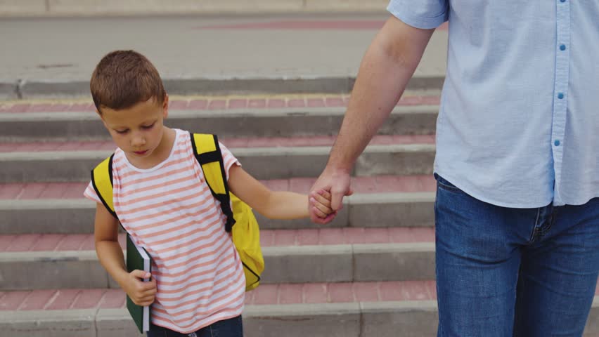 Child crosswalk hand backpack school run student boy father pedestrian crossing zebra pedestrian car sign road. family striped traffic rule highway group brother sister man primary outside move safety