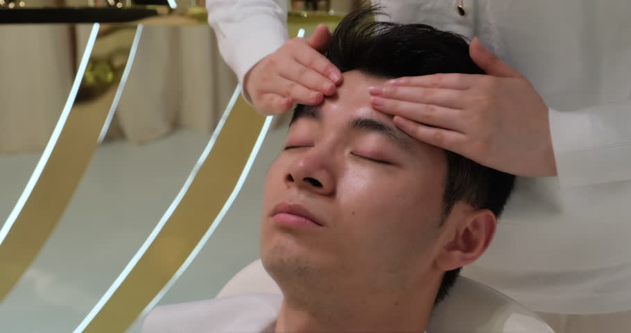 Handsome Asian young man in head and face massage. facial massage, skincare and beauty treatment concept. Slow motion | Shutterstock HD Video #1101494421