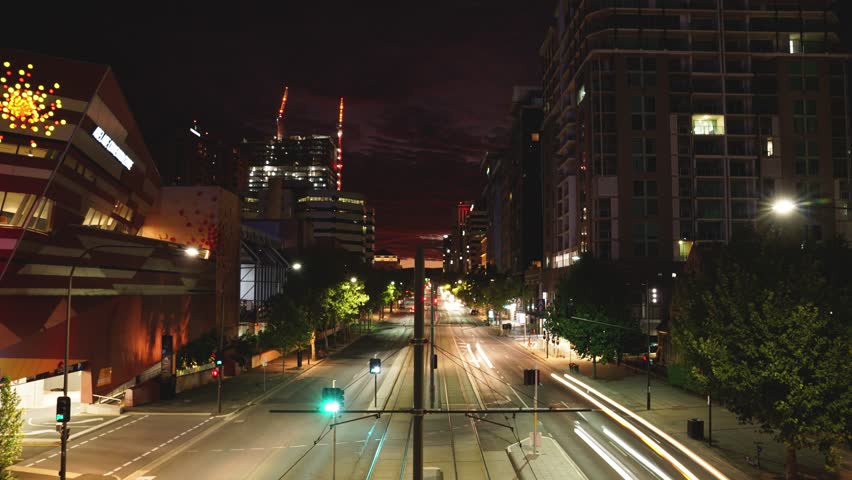Adelaide City sunrise over North Terrace. A beautiful sunrise in Adelaide, South Australia. Time lapse video capturing cars, trams, the skyline and the Adelaide railway station in the distance.