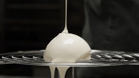 Woman chef confectioner pouring caramel on mousse pink cake, creamy dessert close-up gastro art. Restaurant dessert, Honey biscuits, confit, almond chocolate mousse made with honey and lime zest.  - Powered by Shutterstock - Get 15% off with code: PIKWIZARD15