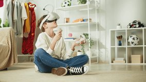 Boy using virtual reality glasses with controllers, playing video games, child gamer wearing new generation gaming headset for entertainment and education at home, future technology concept.