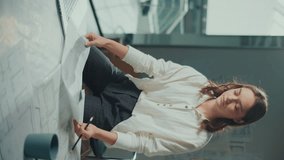 Vertical Video. Female Architect in Her Modern Office Creates Innovative Designs Using Advanced Technologies and Tools She Works On Blueprints, Technical Equipment to Bring Her Creative Vision to Life