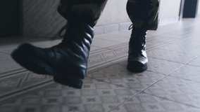 Human legs in black boots walk on snow and earth. - Powered by Shutterstock - Get 15% off with code: PIKWIZARD15