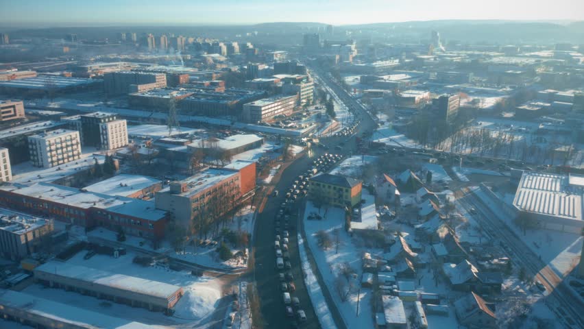 Snow covered winter city, aerial view of traffic on road intersections, highway, street