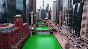 push in amazing chicago aerial between buildings downtown during the St. Patrick's Day Parade cinematic. Bascule bridges with famous chicago buildings in background. Logos blured. Aerial 4k USA - Powered by Shutterstock - Get 15% off with code: PIKWIZARD15
