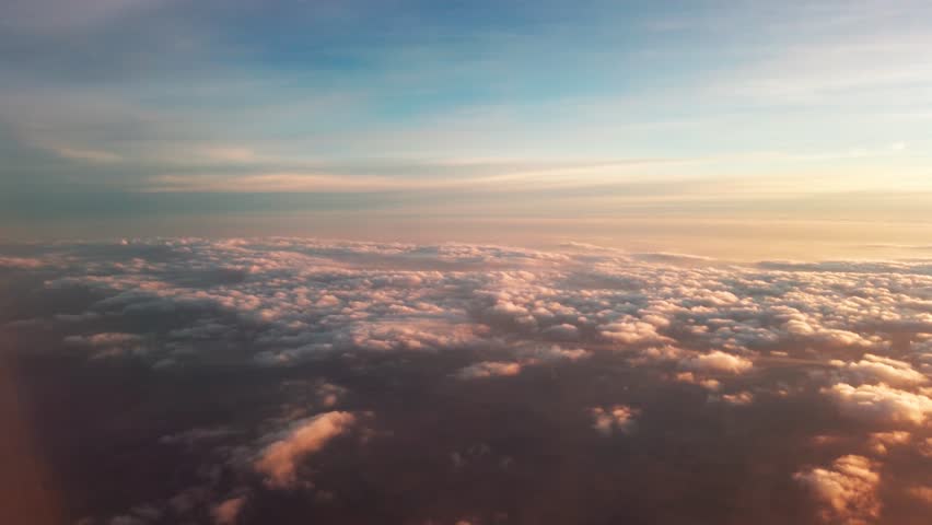 Beautiful sunset sky above clouds with dramatic light. Cabin view from airplane - Powered by Shutterstock - Get 15% off with code: PIKWIZARD15