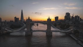 Establishing Aerial View Shot of London UK, United Kingdom, Tower Bridge, push in, candy sunset