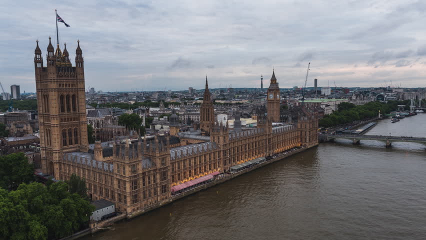 Establishing Aerial View Of London Skyline, Westminster Big Ben, British Parliament, very close, circling right, overcast Royalty-Free Stock Footage #1101505803