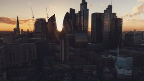 Square Mile, City of London, Establishing Aerial View Shot of London UK, United Kingdom, pull up crane shot, amazing sun 