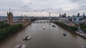 Establishing Aerial View Of London Skyline, Westminster Big Ben, British Parliament, push along Thames, overcast