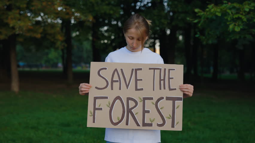 Save the Forest Poster. Young Girl Eco Activist Holding Ecology Poster on the Green Forest Background. Public Demonstration. Protest Against Earth Pollution
