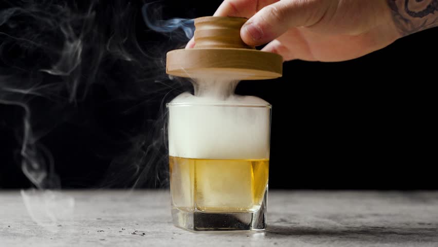 Speed ramp video of smoke rolling off of whiskey cocktail Royalty-Free Stock Footage #1101506911
