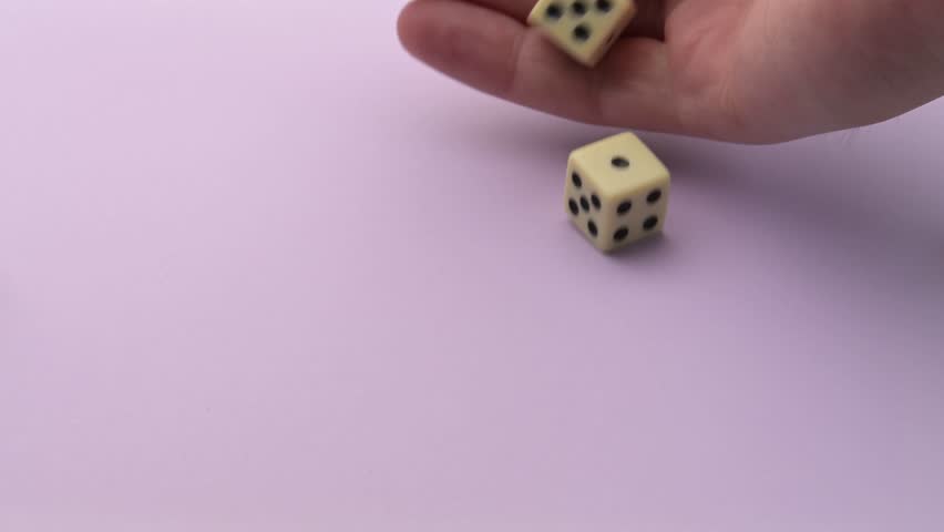 Hand throwing five dice getting random results