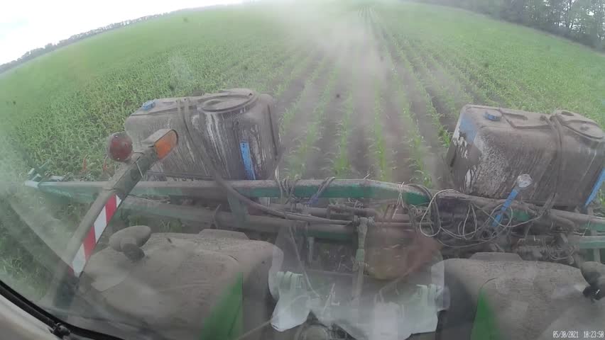 Working inside the green tractor at corn field POV shot