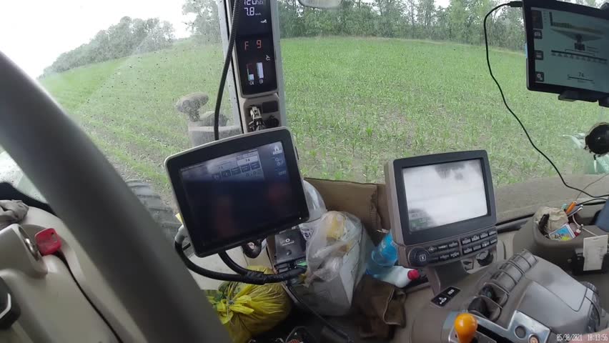 Working inside the green tractor at corn field POV shot