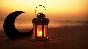 Ramadan Mubarak video Traditional candle on the beach with crescent moon shape during sunset