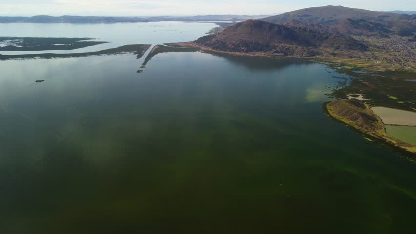 Aerial panorama of Puno with Lake Titicaca in Peru