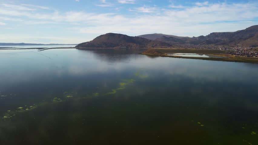 Aerial panorama of Puno with Lake Titicaca in Peru