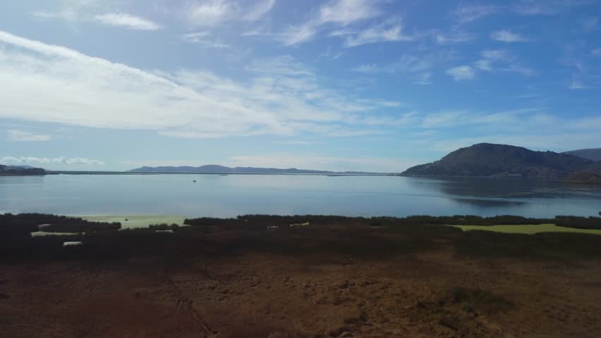 Aerial panorama of Puno with Lake Titicaca in Peru