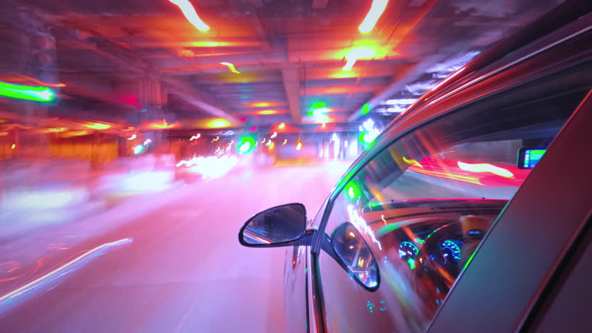 Motion timelapse of a night drive in a city . Side view from the car window 