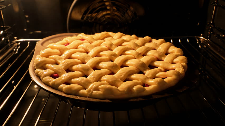 Tasty pie in oven. Timelapse of homemade pie baked. Baking concept. Delicious Apple Pie rising up in oven. Process of baking berry pie with apples baked in oven. 4K, UHD Royalty-Free Stock Footage #1101520129