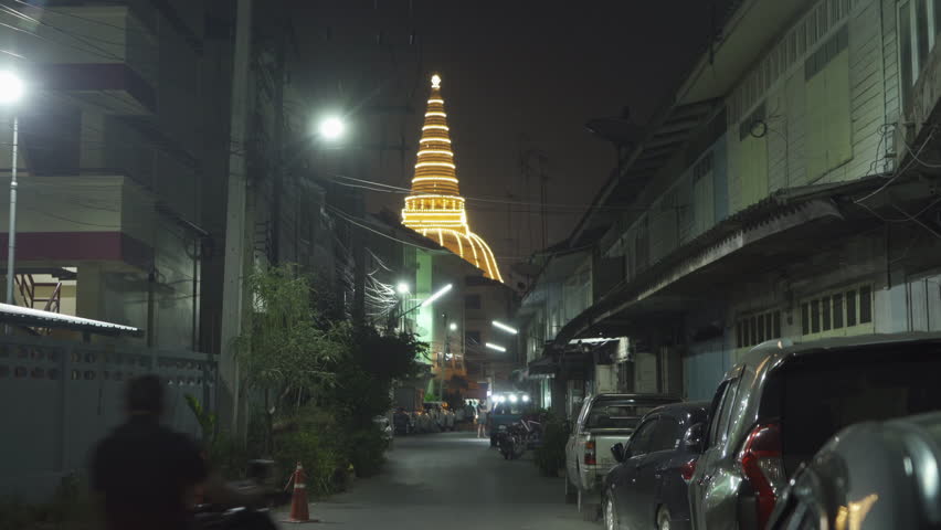 Phra Pathommachedi temple. The golden buddhist pagoda with residential houses, urban city of Nakorn Pathom district, Thailand. Holy Thai architecture.
