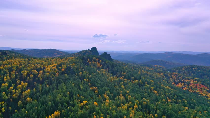 Breathtaking panoramic aerial view   of the autumn forest and rocks,  Autumn season yellow forest on rocky mountain slopes.