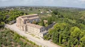 4K aerial - a bird's eye view video (Ultra High Definition) of Abbey of San Giovanni in Venere. Picturesque morning scene of olive garden in Italy, Europe. Traveling concept background.