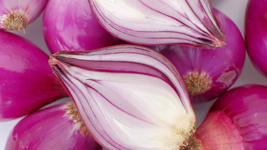 Top view, Red Onion rotation on wooden table, Close up.
