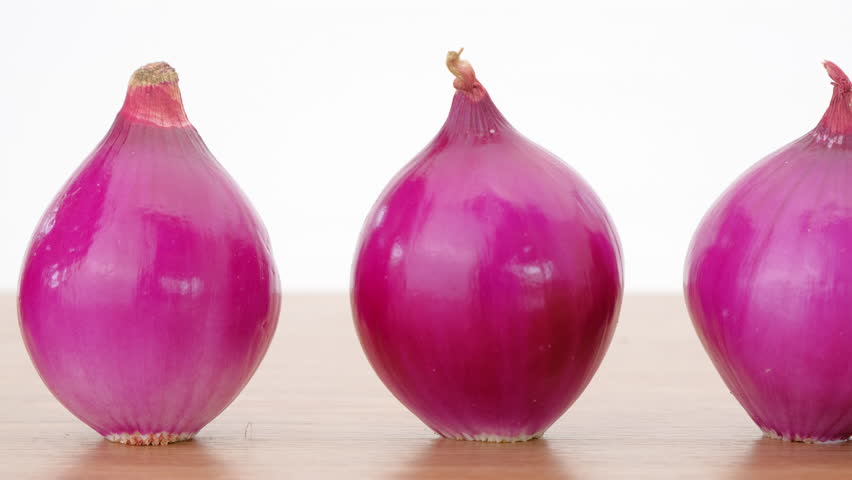 Dolly shot, Red Onion on wooden table, Close up.