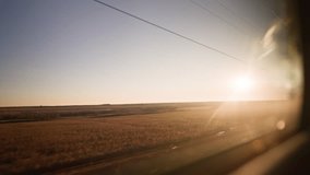 Bullet train rides on the railway track during a beautiful sunset. Journey and trip on train. Interior view at train's empty window. - Powered by Shutterstock - Get 15% off with code: PIKWIZARD15