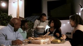 Family dinner: Happy African American people dining together at home terrace outdoors - Healthy food lifestyle - Powered by Shutterstock - Get 15% off with code: PIKWIZARD15