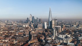 Square Mile, City of London, Establishing Aerial View Shot of London UK, United Kingdom, slow tracking left, winter, snow on the roofs