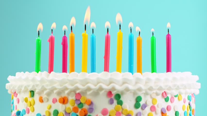 Birthday Cake With Burning Colorful Candle on Pastel Blue Background. Super Slow Motion, 1000 FPS.