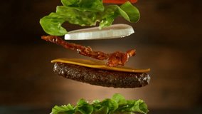 Beef Burger Ingredients Falling and Landing in the Bun. Super Slow Motion at 1000 fps. - Powered by Shutterstock - Get 15% off with code: PIKWIZARD15