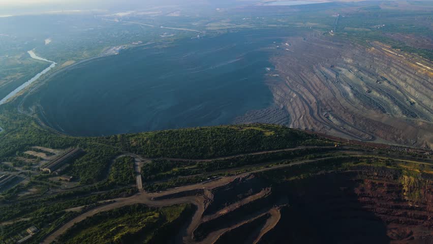 Panorama aerial view shot open pit mine coal mining, dumpers, quarrying extractive industry stripping work. Big Yellow Mining Trucks. View from drone at opencast mining with lots of machinery trucks Royalty-Free Stock Footage #1101538835