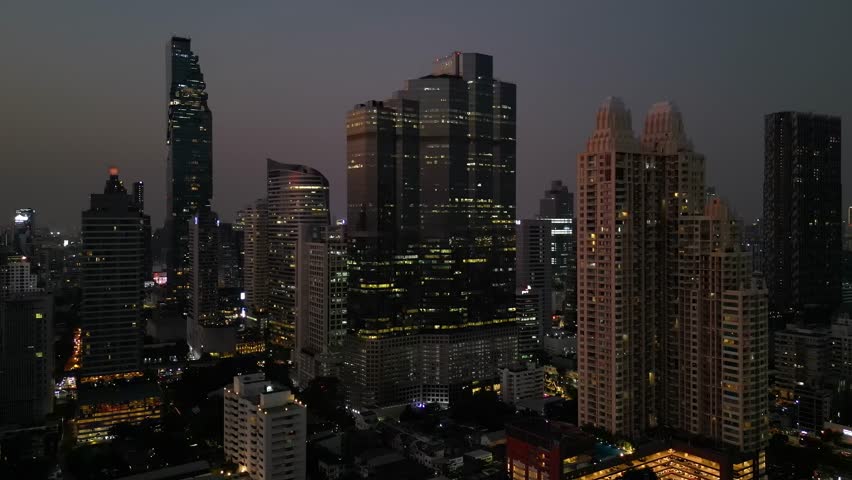 Aerial Drone Footage of Bangkok Vibrant and Dynamic Central Business District Sathorn, Bangkok City at Night from Above