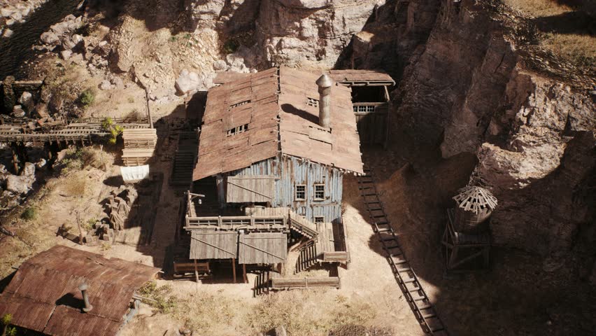 Camera is panning above an old western lumber mill building in a west town village