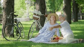 Romantic senior couple taking selfie during picnic in summer park, leisure time - Powered by Shutterstock - Get 15% off with code: PIKWIZARD15