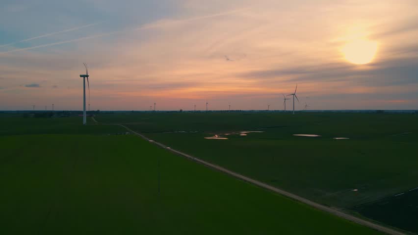 Wind turbines on wind farm field generating clean renewable energy for sustainable development at amazing sunset. Electricity, ecological saving and alternative power source | Shutterstock HD Video #1101545655