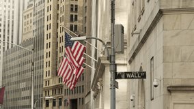 Famous Wall street and the building in New York, New York Stock Exchange with patriot flag. Wall Street road sign in the corner of New York Stock Exchange. New York Stock Exchange - Powered by Shutterstock - Get 15% off with code: PIKWIZARD15