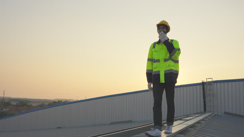 Professional engineer work to maintenance of photovoltaic panel system. Attractive technician worker working on roof inspect and check solar cell panels equipment box at solar cell field during sunset | Shutterstock HD Video #1101549977