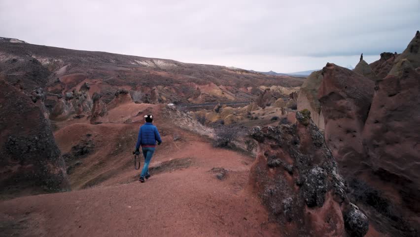 Caucasian Woman Tourist Enjoy Freedom And Travel Holidays Outdoors Walk Between Fairy Chimneys In Devrent Valley, Cappadocia