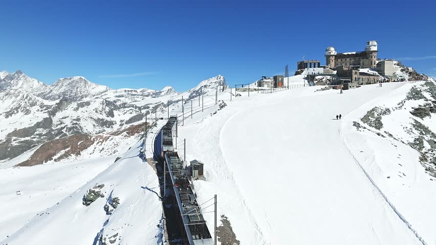 Zermatt, Switzerland -The train of Gonergratbahn running to the Gornergrat station and observatory  in the famous touristic place with clear view to Matterhorn.