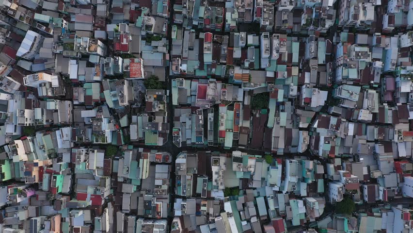 Top down of high density urban rooftops in district four port area along the Saigon river in Ho Chi Minh City, Vietnam. Camera rotation.