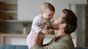 Unconditional father love. Close up portrait of happy loving father holding his lovely adorable baby daughter on hands, hugging and rubbing noses, tracking shot, slow motion, empty space - Powered by Shutterstock - Get 15% off with code: PIKWIZARD15