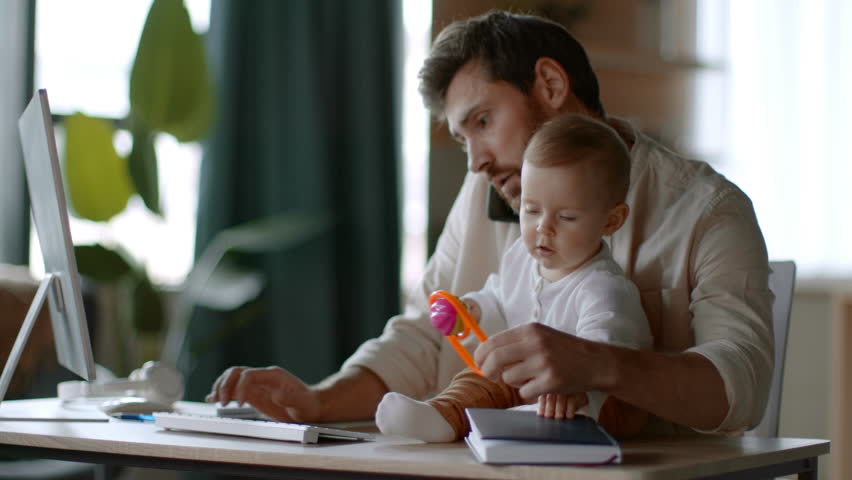 Successful business and parenting. Man manager talking on phone and working on laptop, babysitting with little daughter, cute girl sitting on desk with daddy, tracking shot, slow motion, free space | Shutterstock HD Video #1101571179
