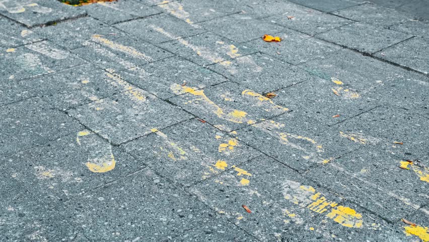 Shoe Footprints Stains from Spilled Paint on Sidewalk Paving