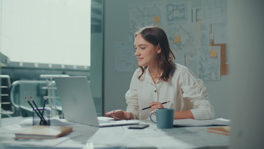 Confident Female Engineer is Typing on a Laptop Computer, Working Online on a New Project. Motivated Female Manager is Doing a New Project. Engineering and Creativity New Product Development Royalty-Free Stock Footage #1101594603
